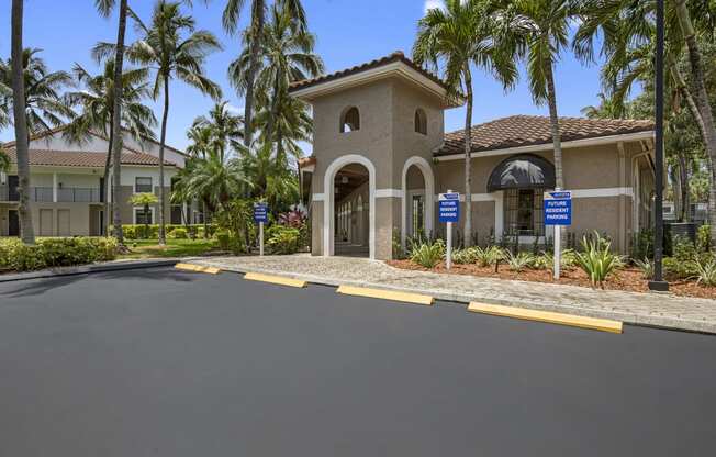 a home with a driveway and palm trees in the background