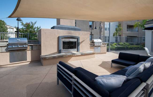 A patio with a couch and a fireplace.