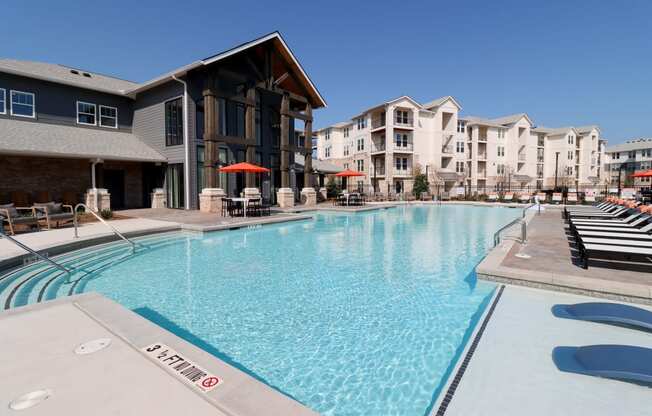 a large swimming pool with apartments in the background at The Crest at Acworth, Georgia