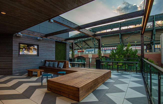 a communal area with a wooden bench and a glass roof