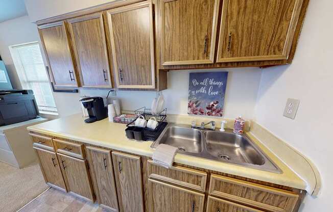 A kitchen with wooden cabinets and a sink.