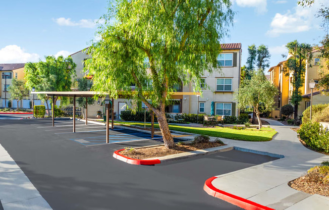 an empty parking lot in front of an apartment building