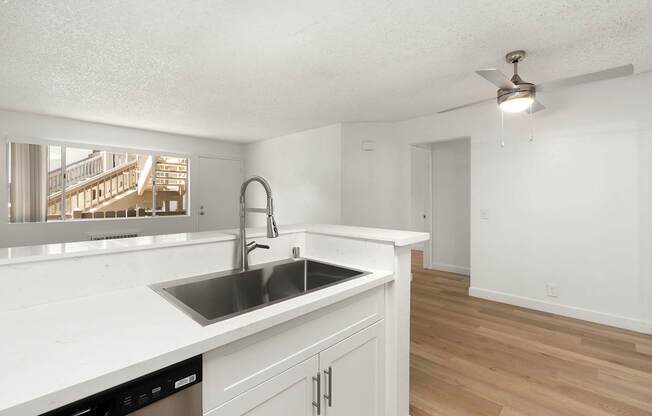 A kitchen with a sink and a window.