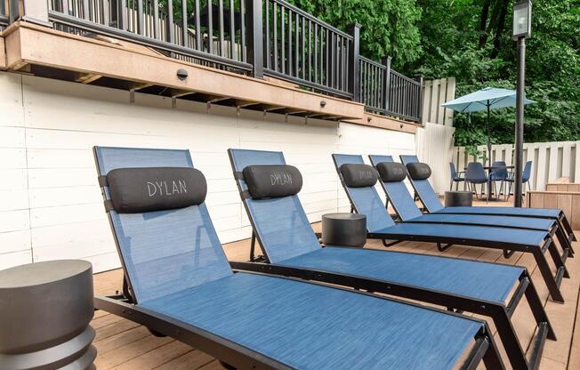 a wooden bench sitting next to a fence