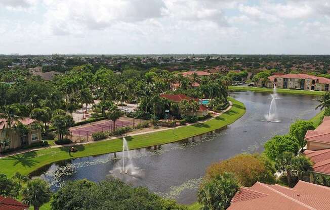 A view of a lake with a fountain in the middle of it.