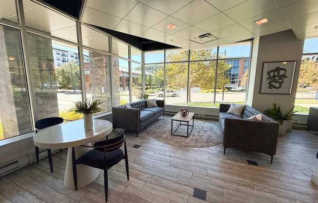 A modern living room with a large table and chairs.
