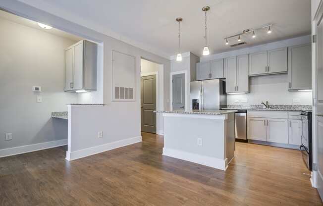 kitchen with hardwood-style flooring, island, and a built-in desk