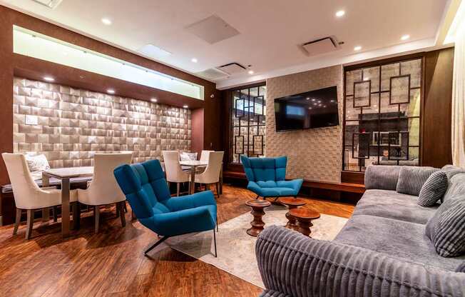 a living room with a couch and chairs and a table and a television