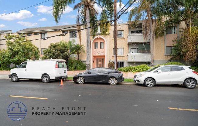 three cars parked in front of an apartment building