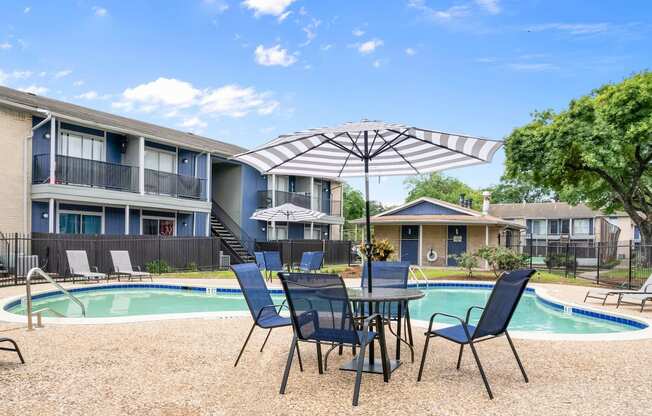 our apartments have a pool and a patio with chairs and umbrella