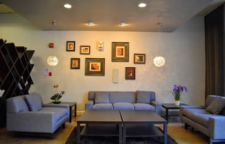 View of leasing office with seating, coffee table, well decorated, and recessed lighting