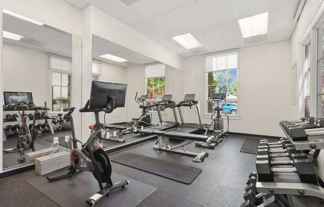 the gym with treadmills and other exercise equipment at the belgard apartments