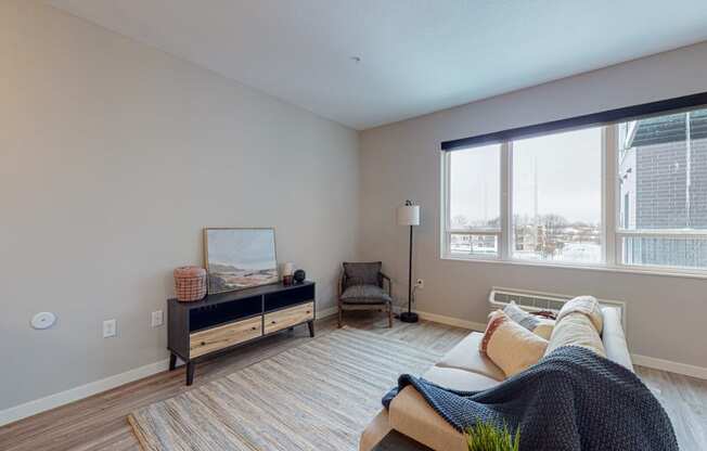 a living room with a large window and a couch