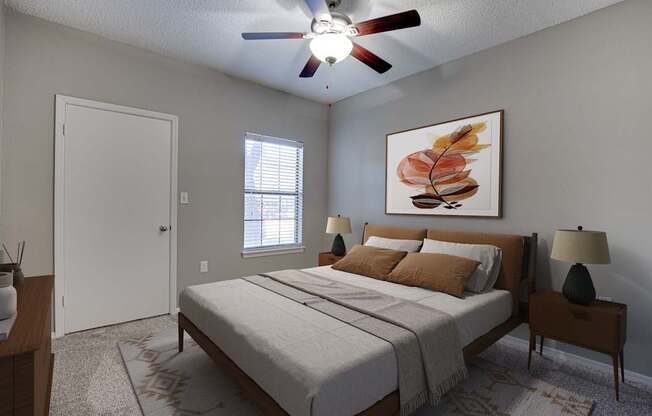 A bedroom with a bed, nightstand, and a painting on the wall.