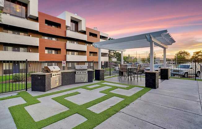 A modern building with a green lawn in front.