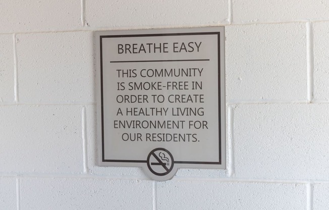 a sign that says breathe easy this community is smoke free in order to create a