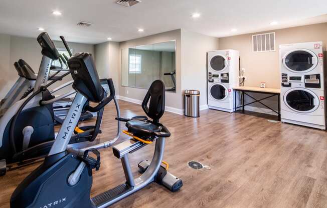 Fitness center at Ashton Brook Apartments features washers and dryers