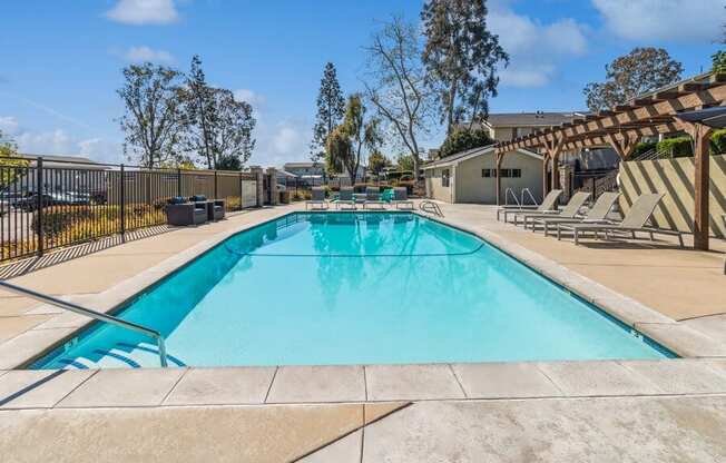 Community Pool & Pool Furniture at Forest Park Apartments in El Cajon, CA.