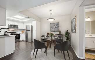 a dining room with a table and black chairs