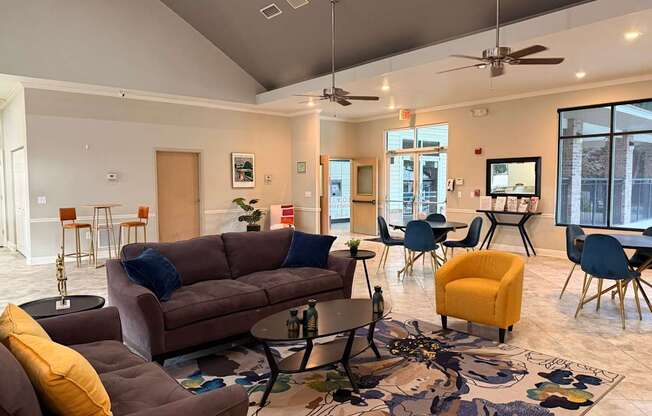 A living room with a brown couch, a yellow chair, and a rug with a floral pattern.