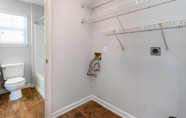 a small bathroom with a toilet and a shower and a rack on the wall