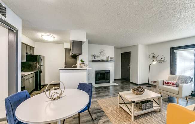 an open living room and kitchen with a table and chairs