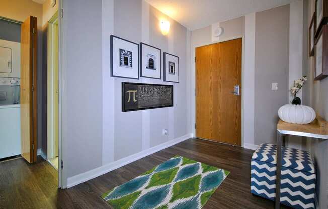 a living room with a rug and pictures on the wall