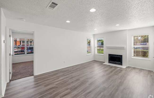 the living room and dining room of a new home with a fireplace