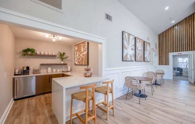 a kitchen and dining area with a bar and a living room