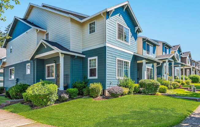 A row of townhomes with blue and white siding at The Landing Apartments and Townhomes, Oregon, 97045