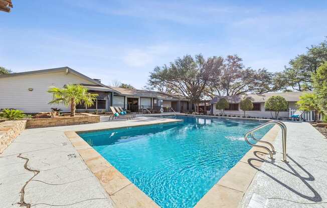 A swimming pool with a slide in the middle of it.