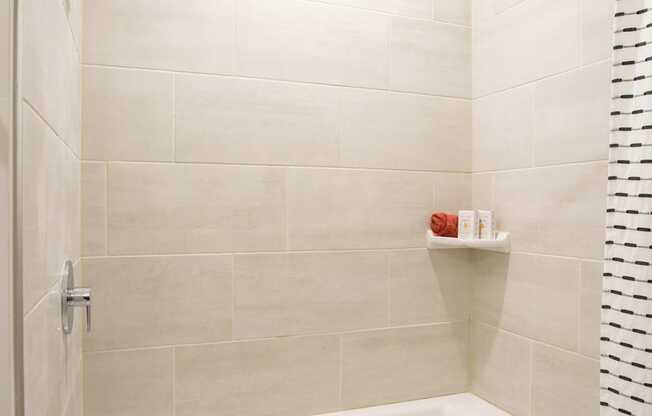 a white bath tub in a bathroom with a shower curtain