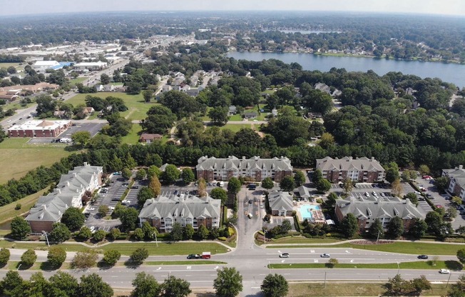 arial view of a large suburban neighborhood with a lake in the background