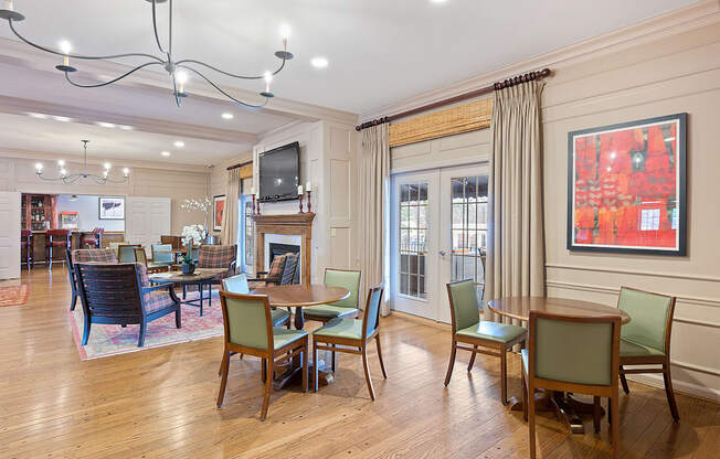a living room with tables and chairs and a fireplace