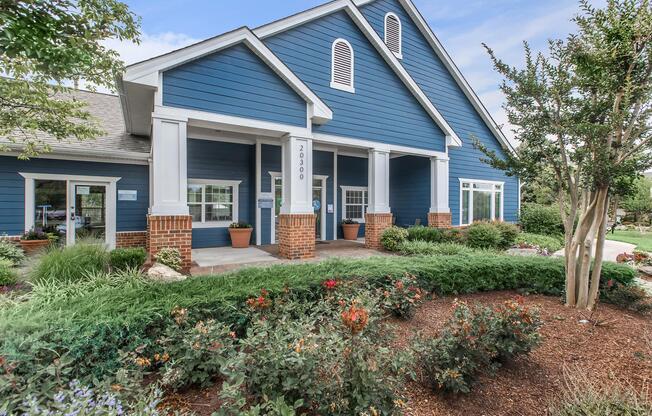 a house with bushes in front of a building