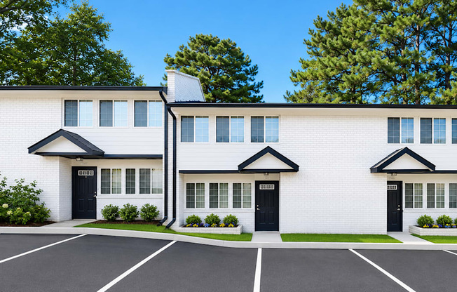 A row of white houses with black doors and windows.