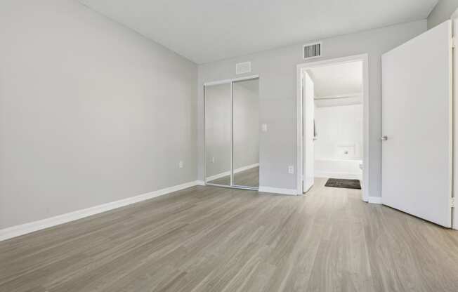 an empty living room with white walls and wood flooring at Pembroke Pines Landings, Pembroke Pines 