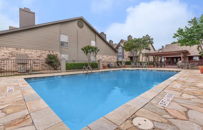 a house with a pool in front of a building