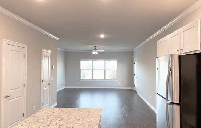 B2 (2-car) Downstairs open concept living and dining with laminate wood flooring