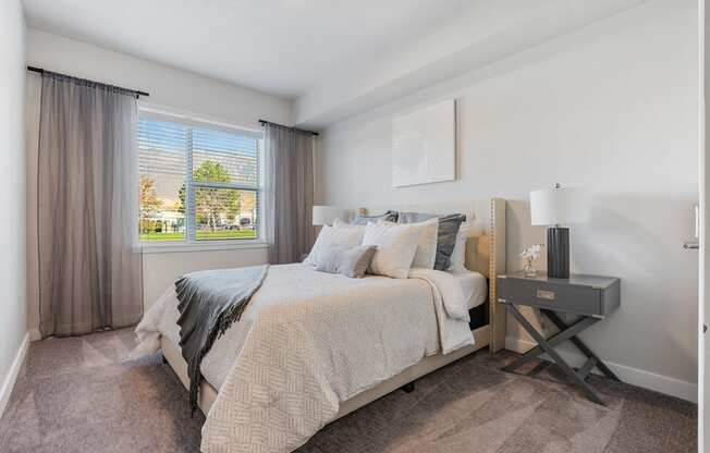 a bedroom with a bed and a window