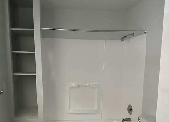 A modern bathroom with a shower and a toilet.