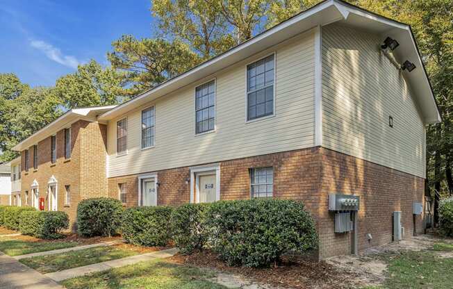 a brick and with bushes and trees