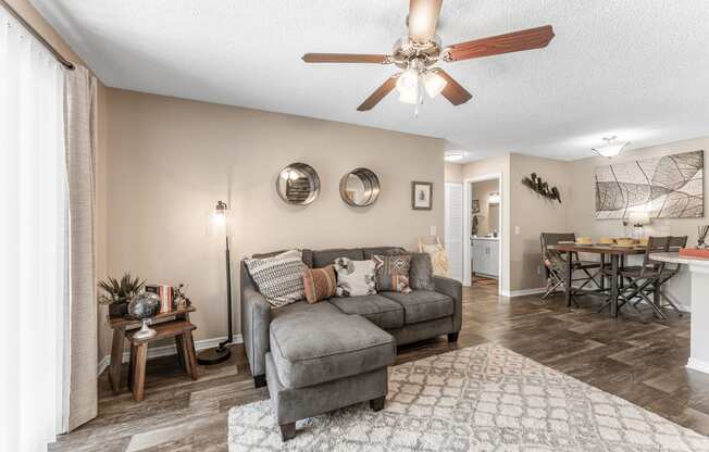 a living room with a couch and a ceiling fan