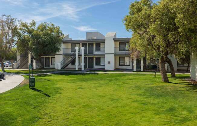 A modern building with a green lawn in front.