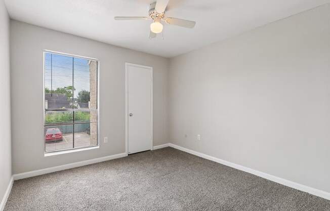 A room with a car parked outside the window.