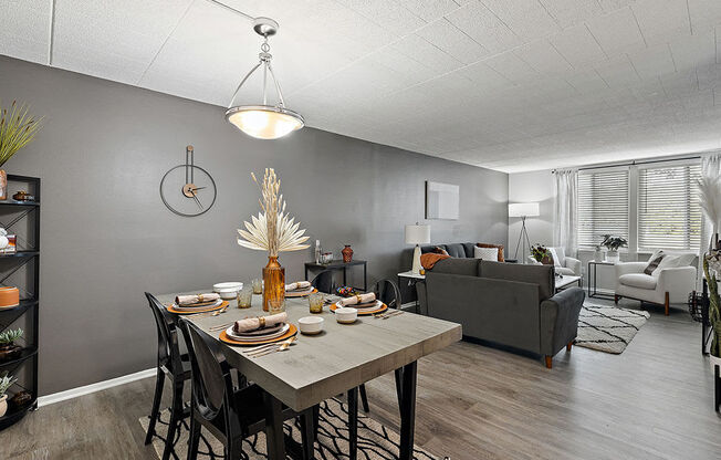 A dining room with a table set for a meal.