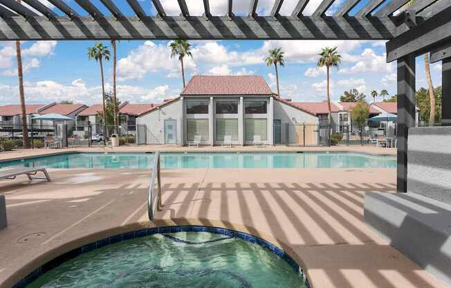 A pool with a hot tub in the middle of it.
