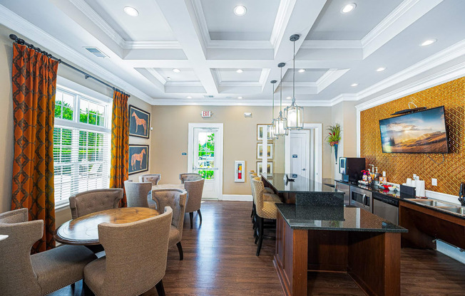 a living room with tables and chairs and a bar