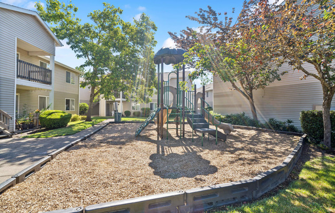 a playground with a swing set in the middle of a yard