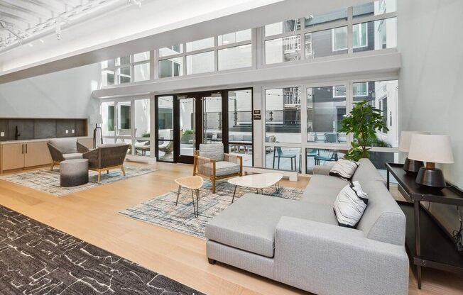 Interior lounge with large sun windows at TL Residences